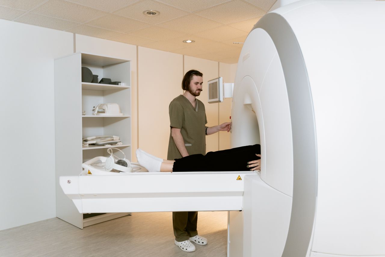 The Art of Drawing Readers In: Your attractive post title goes here Medical professional assisting a patient during an MRI scan in a hospital setting.