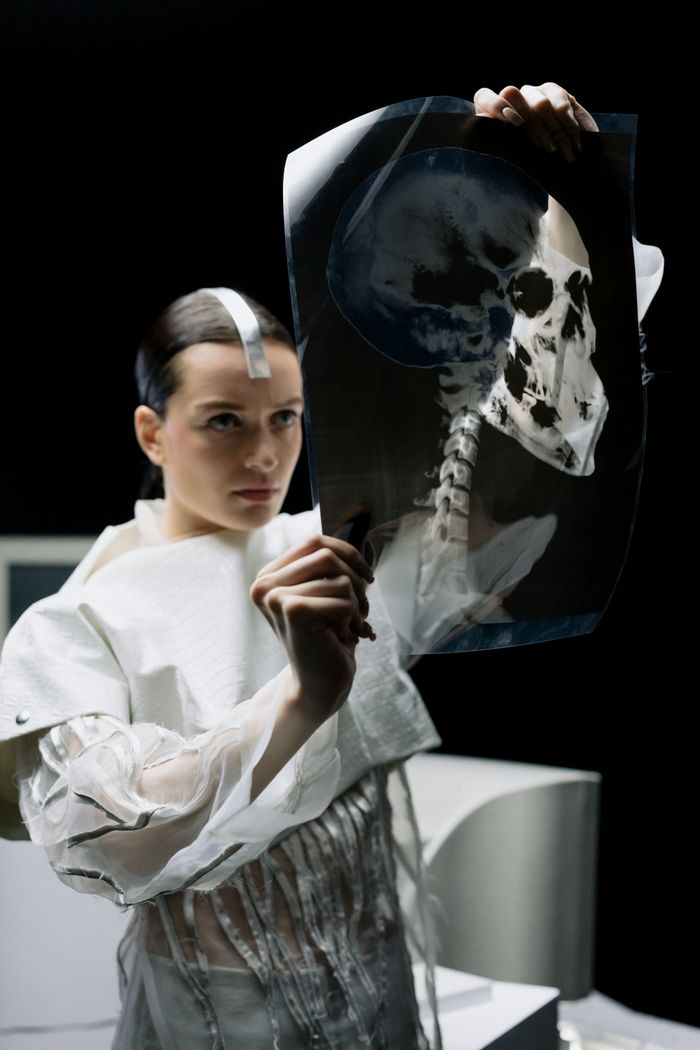 Mastering the First Impression: Your intriguing post title goes here A female scientist examines a human skull X-ray in a laboratory setting, highlighting medical research.